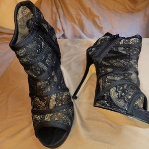 Black lace open toe stiletto heels.
